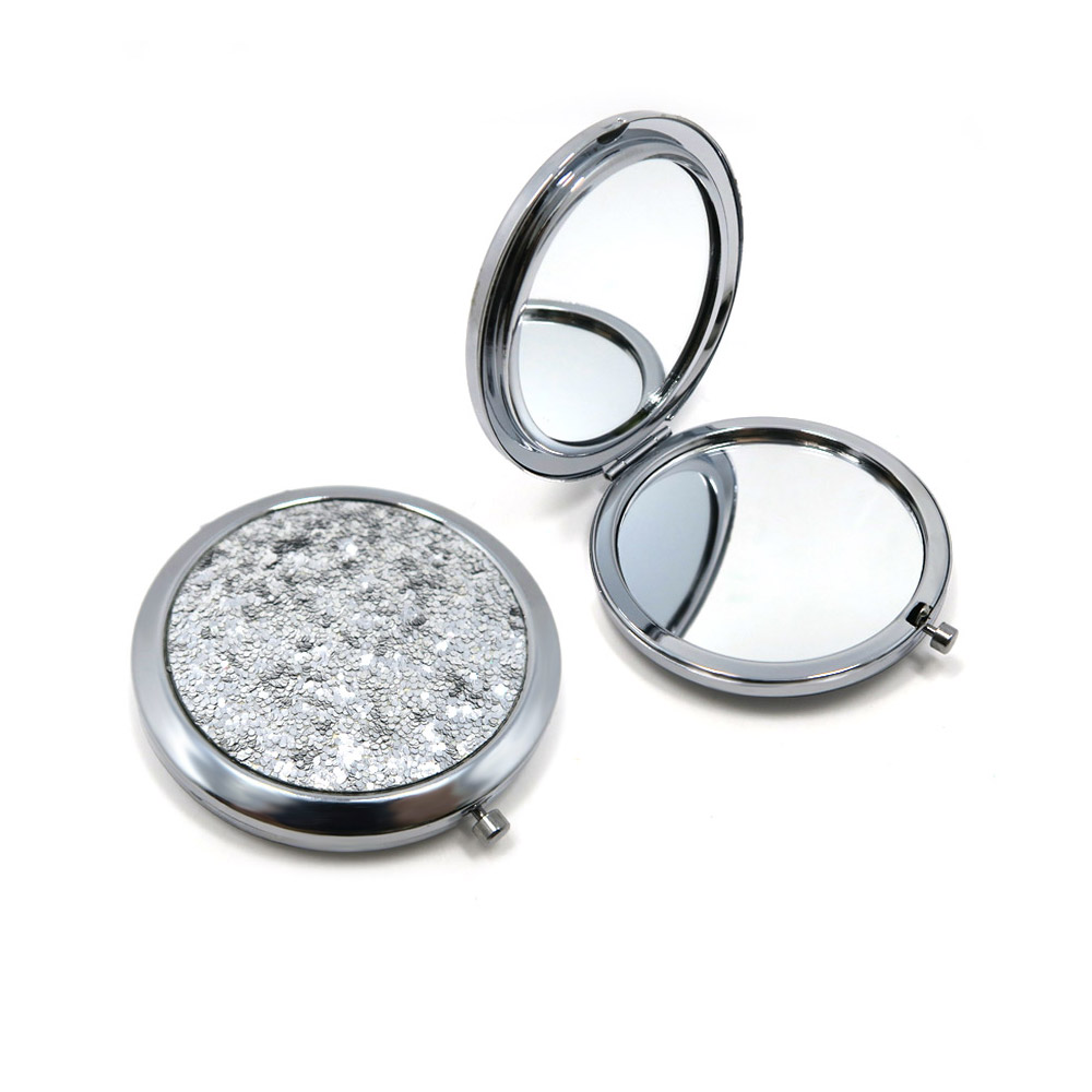 Detailed view of the Sequin Compact Mirror's texture and dual mirrors