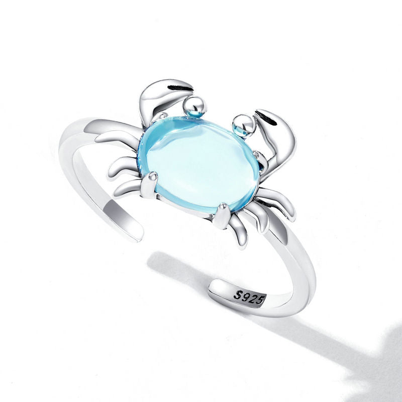 Detailed view of the S925 sterling silver crab ring with a vibrant blue crystal