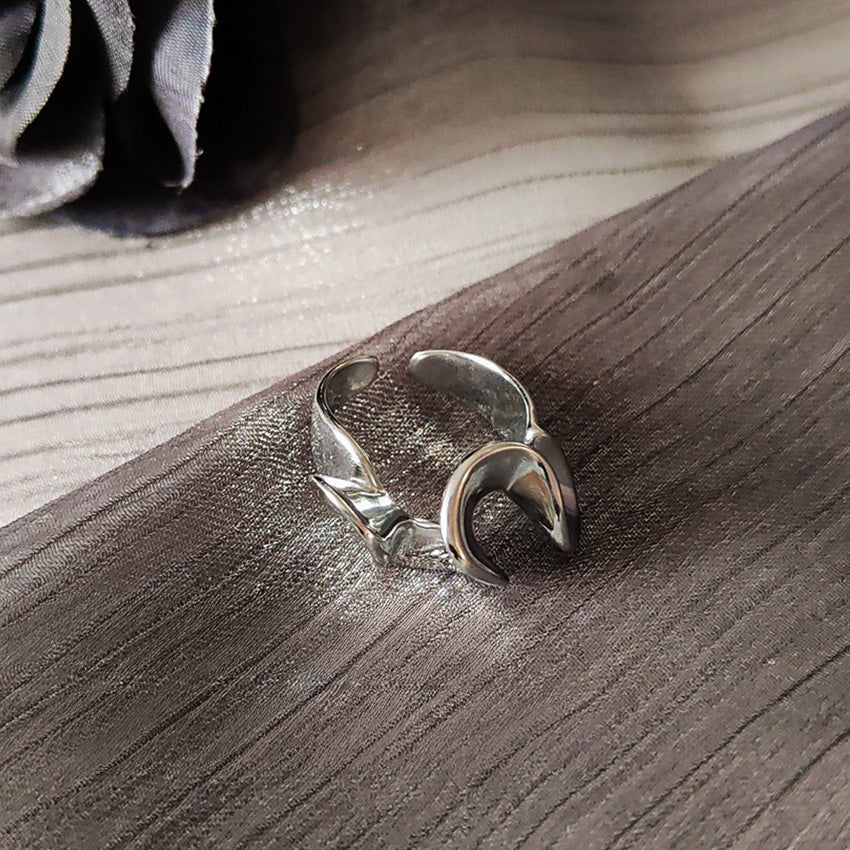 A silver adjustable ring with a unique crescent design from the abstract collection.