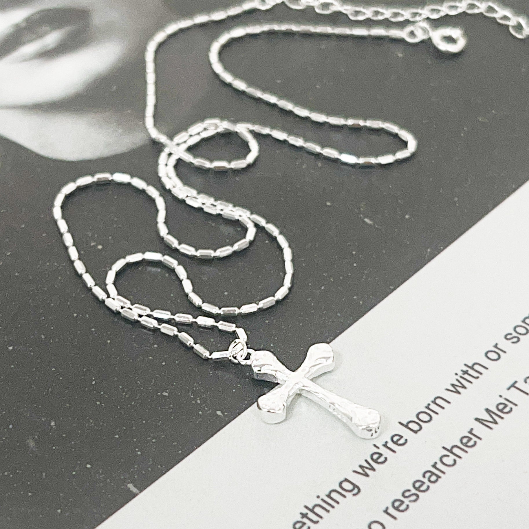 Detailed product view of the sterling silver cross necklace