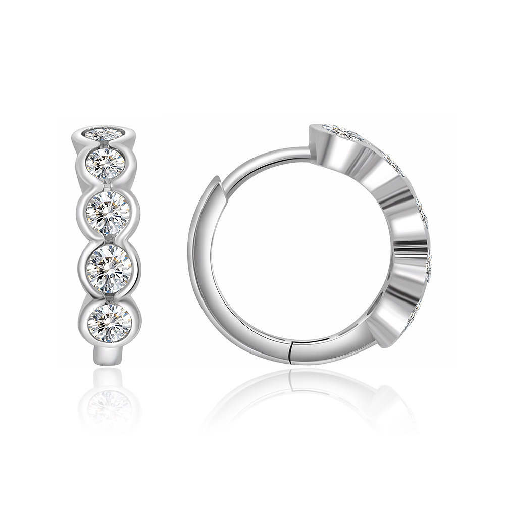 A sleek, modern silver mini huggie hoop earring with cubic zirconia