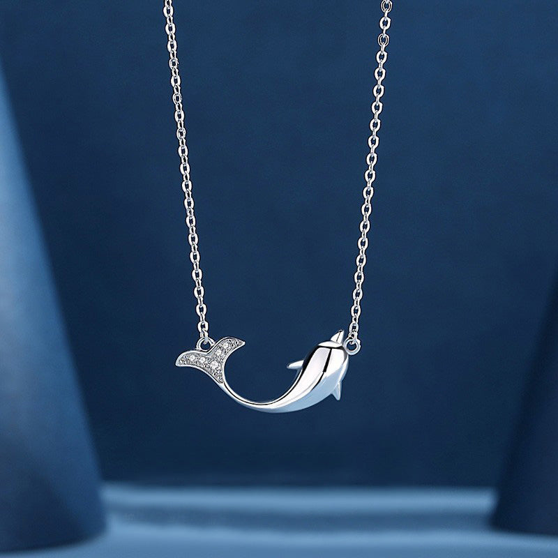 Close-up of the silver dolphin pendant on a sterling silver chain