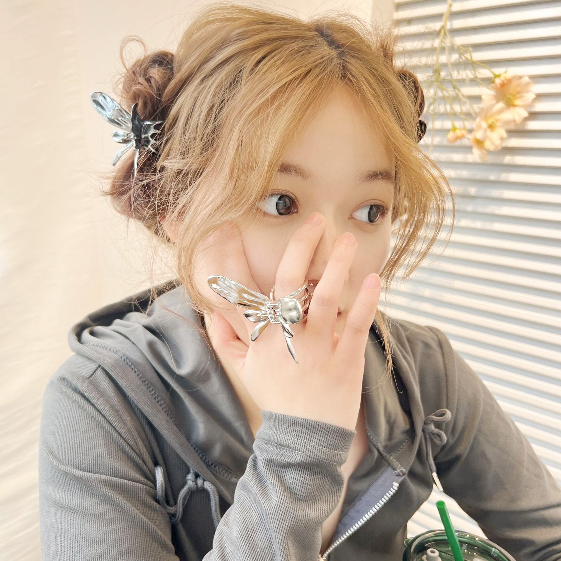 A model wearing the stylish metal butterfly hair clip, adding a fashionable touch to her look.