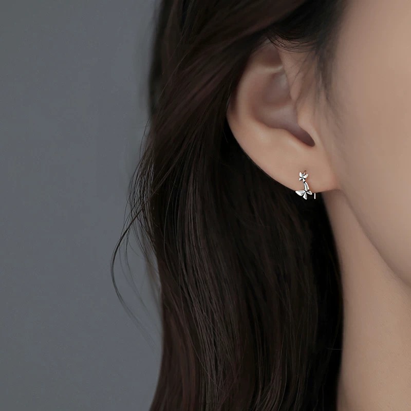 Model wearing a hypoallergenic 925 silver butterfly earring