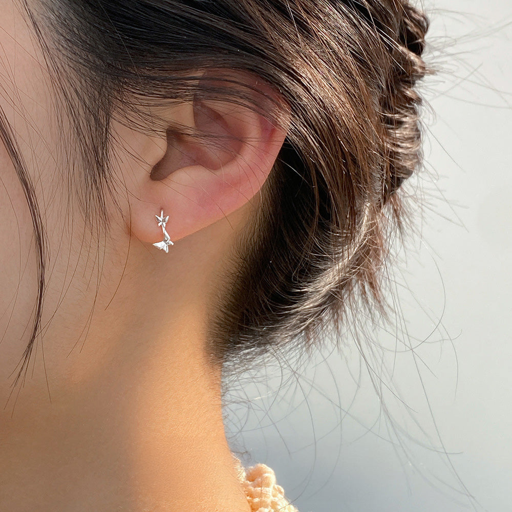 A woman wearing a stylish sterling silver hook earring from the 5-pair collection.