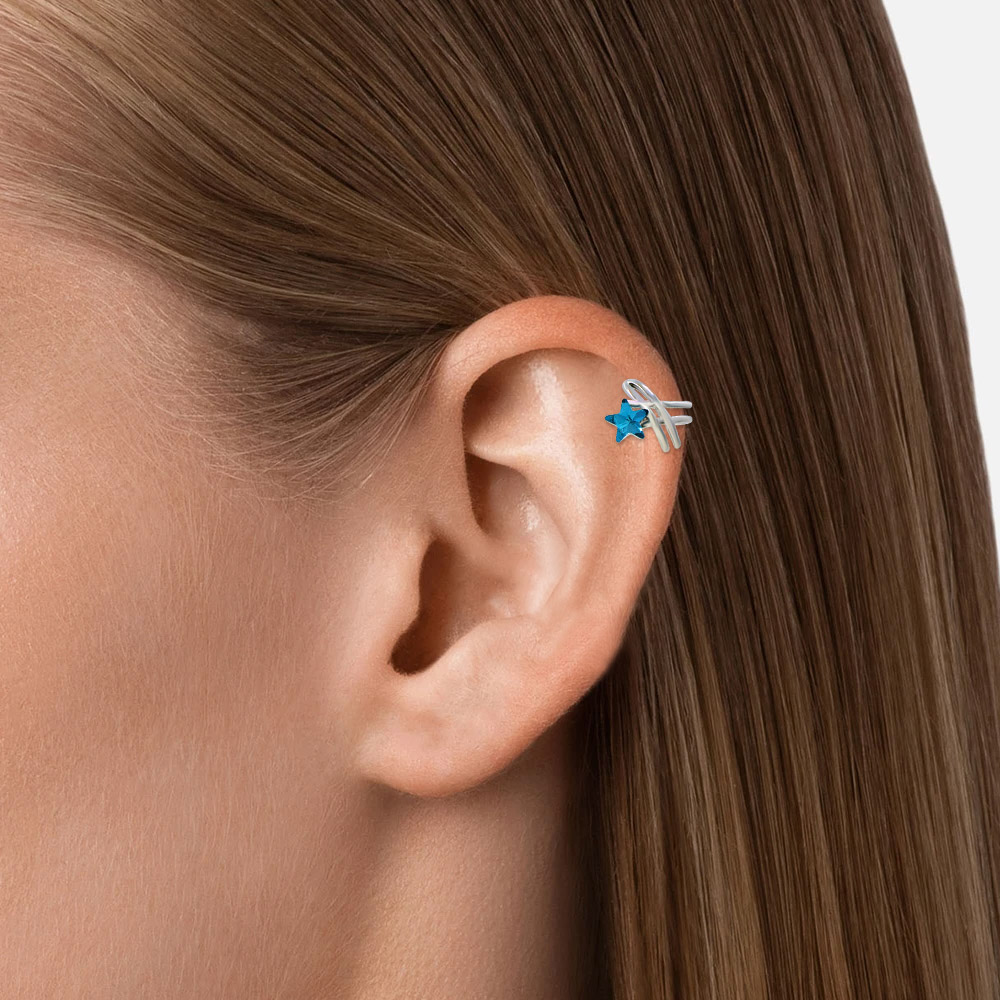 Model showcasing the Blue Star Shaped Ear Cuff Earring on her ear.