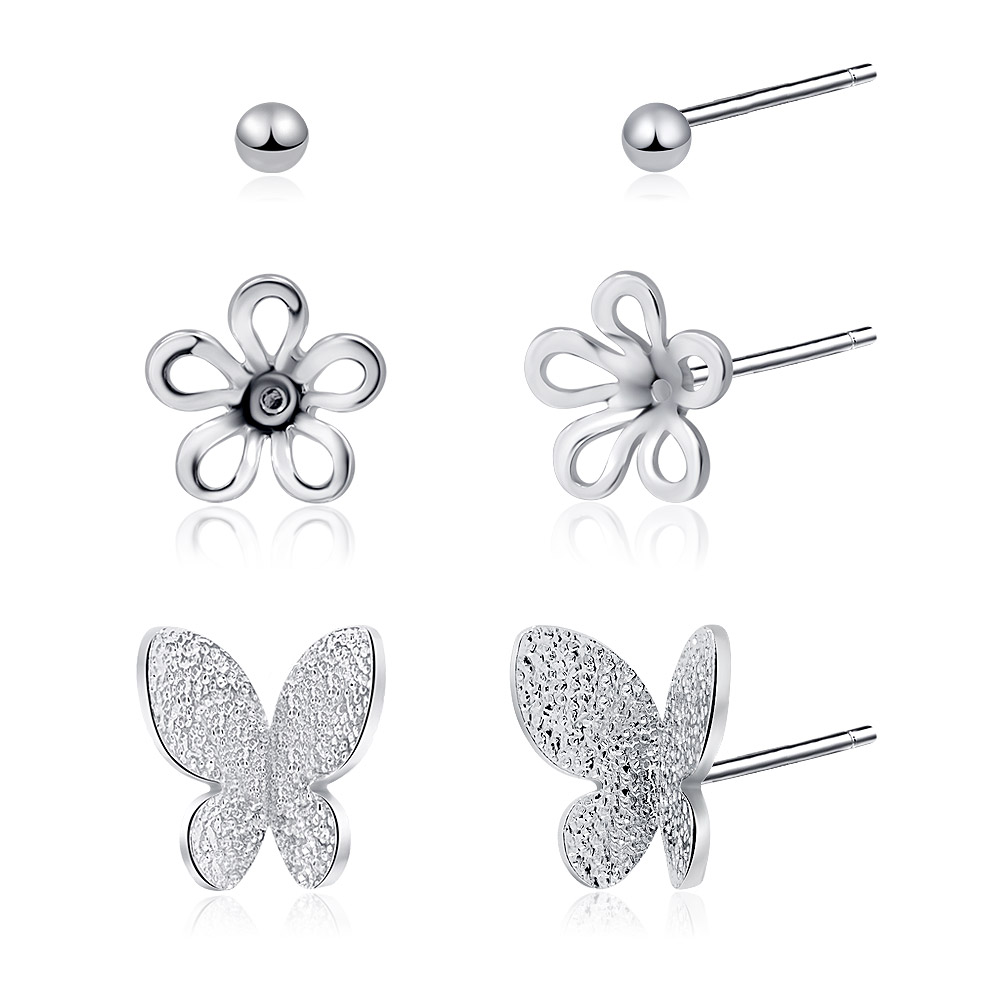 Detailed view of the flower and butterfly stud earrings