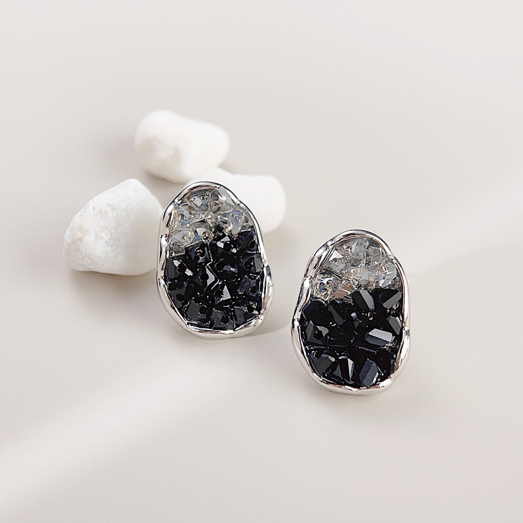 Detailed view of the sparkling black and clear stones in a silver setting