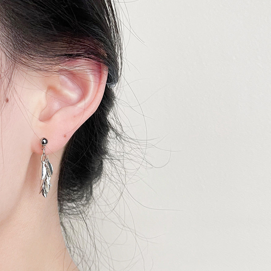 Model wearing the silver leaf statement drop earring to show scale and style.