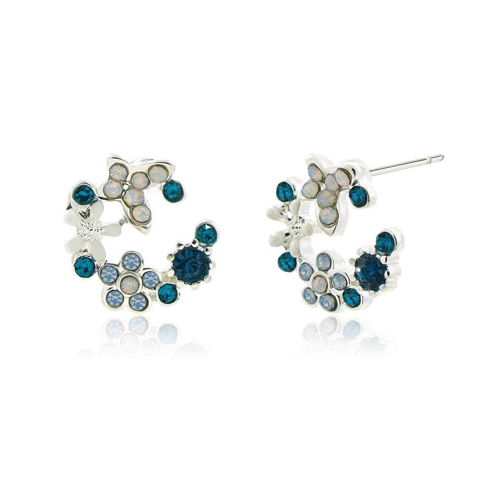 Side view of the blue and white enamel flower earrings showing the crystal details.