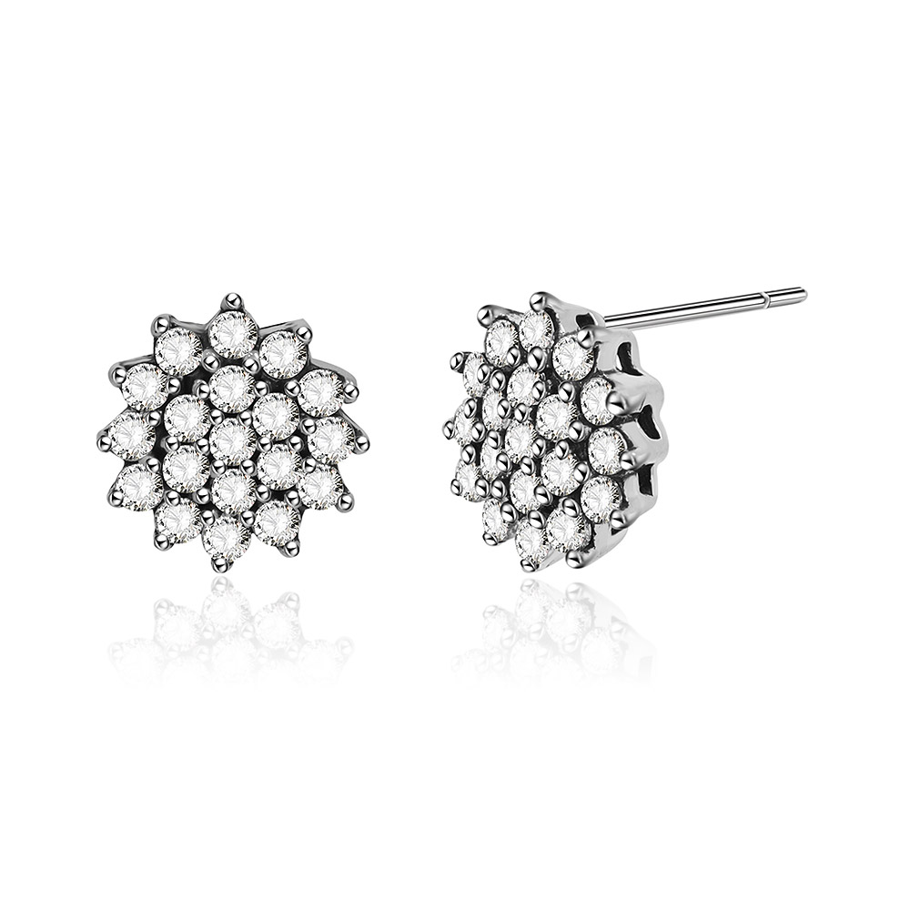 Detailed close-up of the cubic zirconia stones on the silver flower earrings.