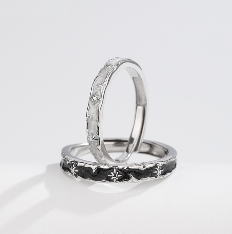 A pair of 925 sterling silver couple rings with an intricate floral pattern