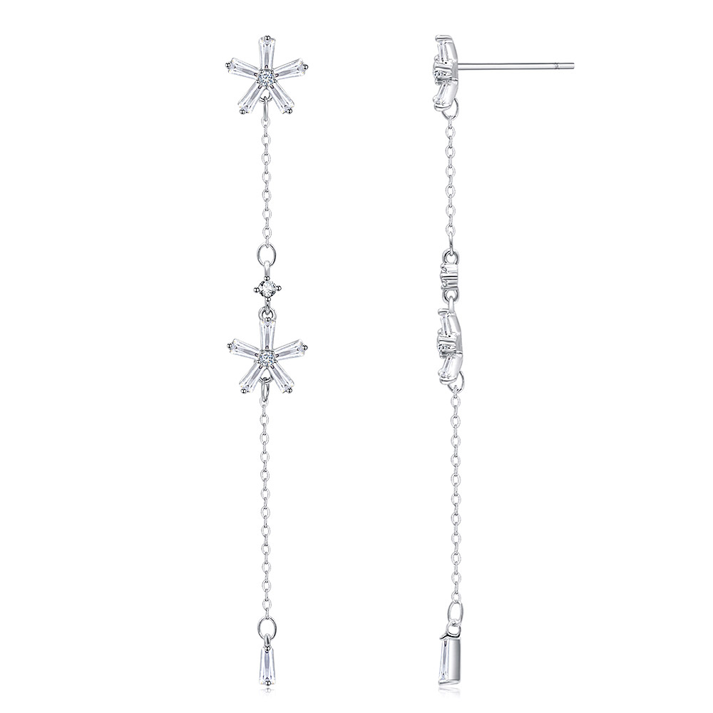 Detailed view of the intricate flower and chain design on the diamond dangle earrings.