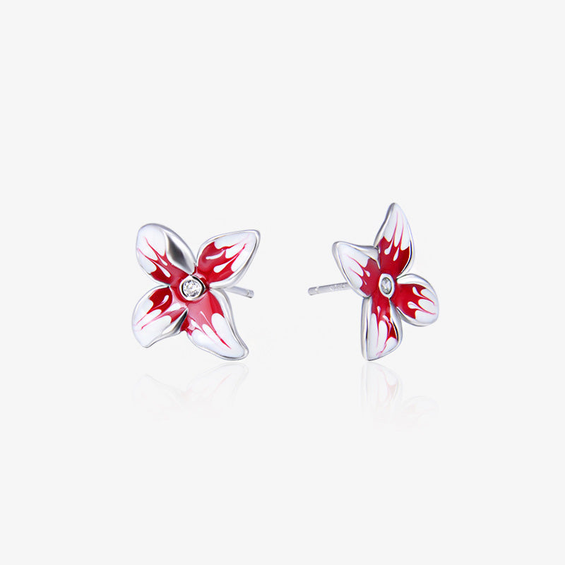 Detailed view of the red enamel 3D flower stud earrings