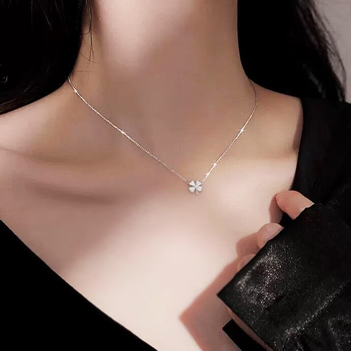 Model wearing the elegant silver four-leaf clover necklace