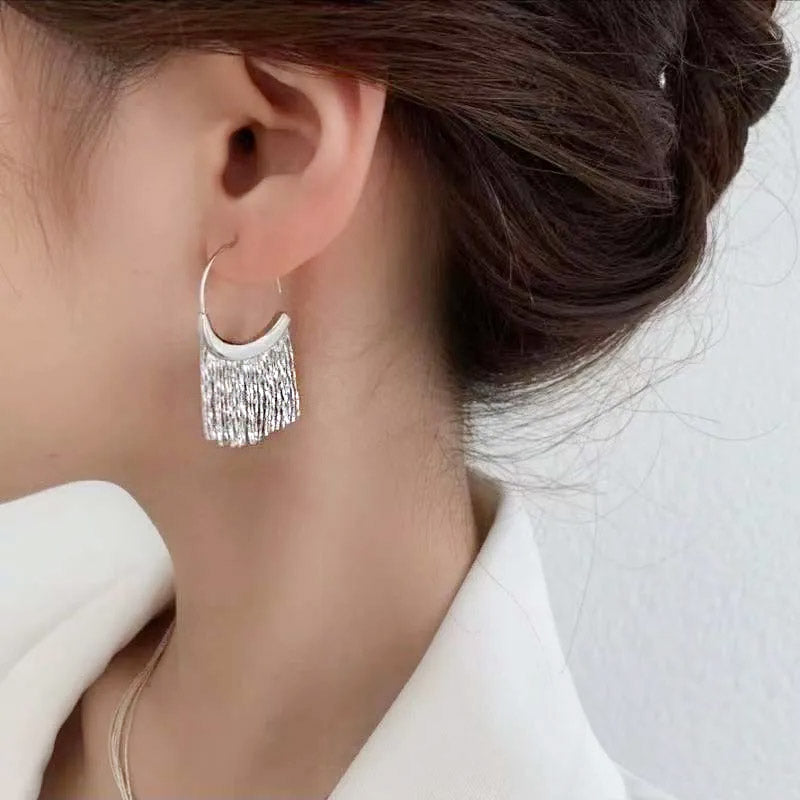 Model showcasing the elegant drape of the 925 sterling silver tassel earrings.