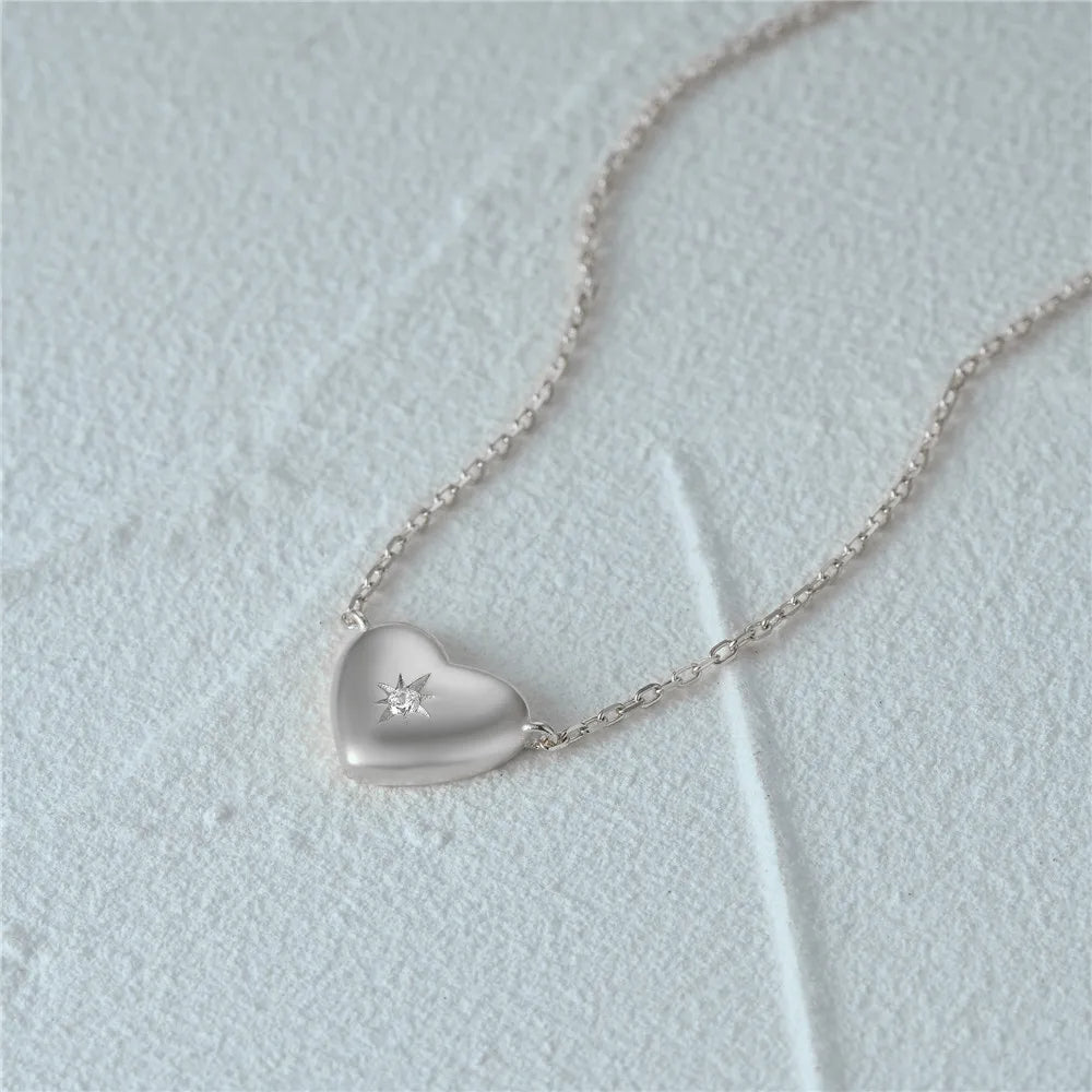 Detailed view of the silver heart pendant with starburst design