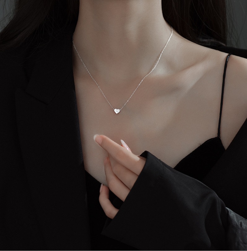 Detailed view of the silver heart-shaped necklace