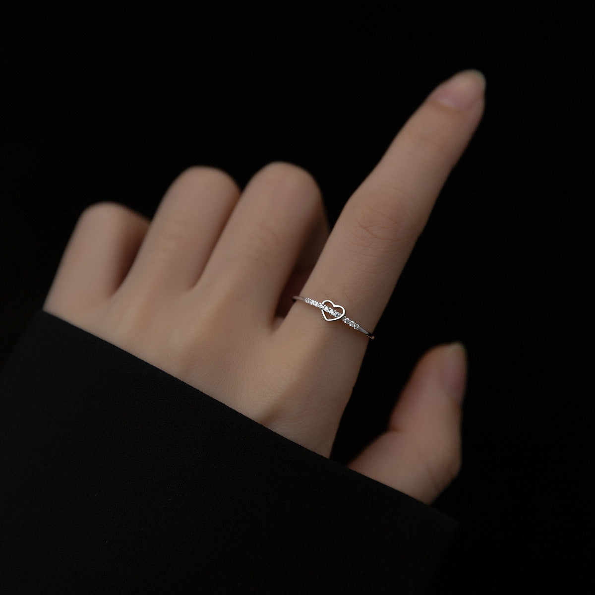 A model showcasing the elegant fit of the 925 sterling silver adjustable heart ring.