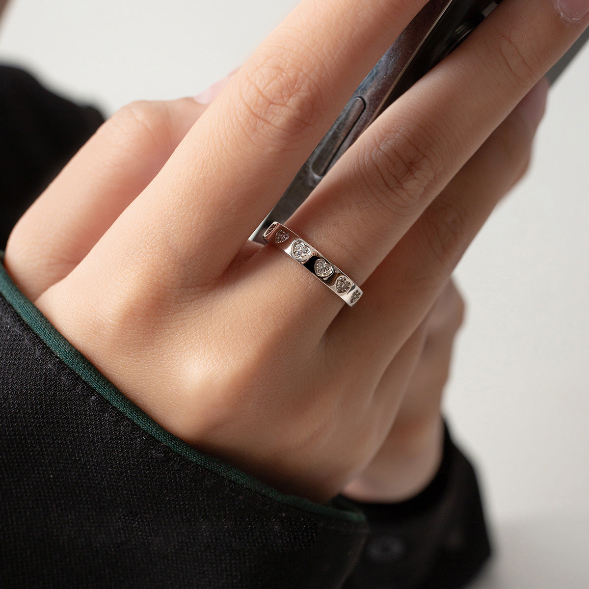 A model wearing the adjustable silver heart zircon ring