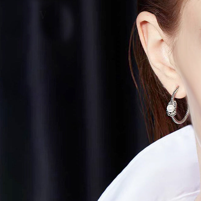 Detailed close-up of the knot rope texture on the silver earring