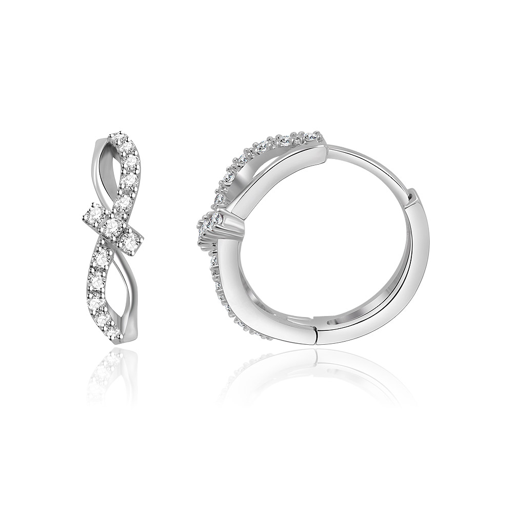 A detailed view of the Interlock CZ Huggie Earrings' infinity design