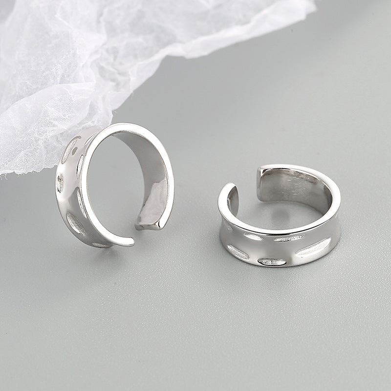 A sterling silver wide helix ear cuff worn for a stylish, no-piercing look