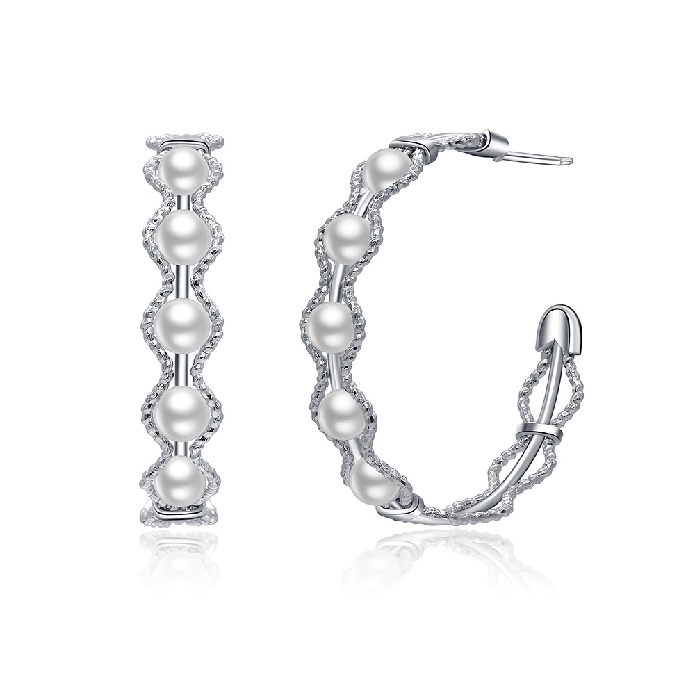 Detailed view of the All Around Pearl Hoop Earrings' twisted design