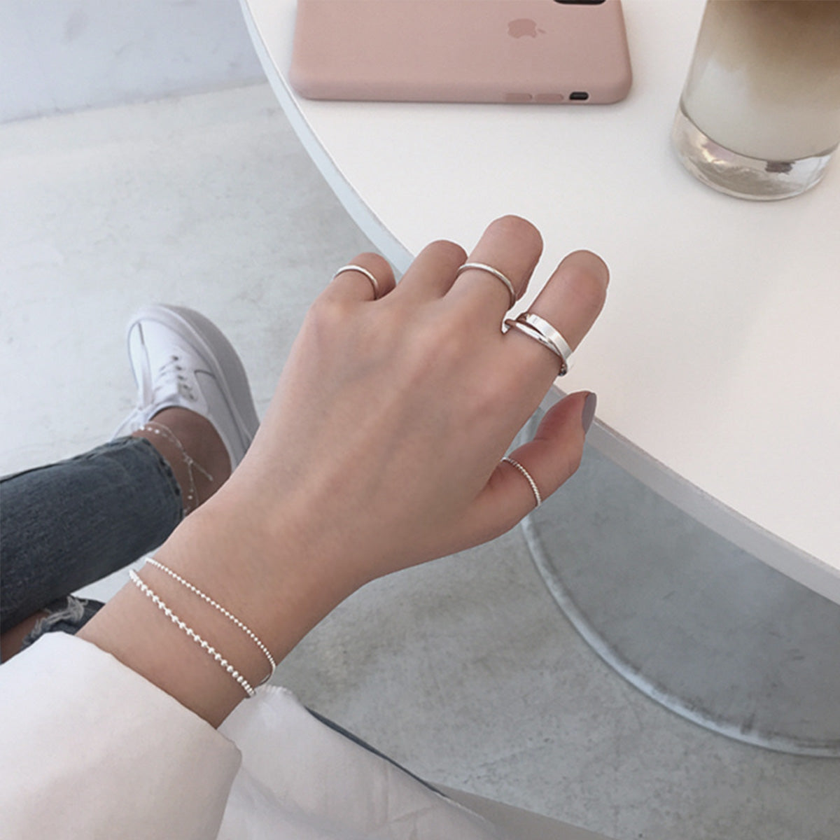 Lifestyle image of the double loop 925 silver ring worn on a hand