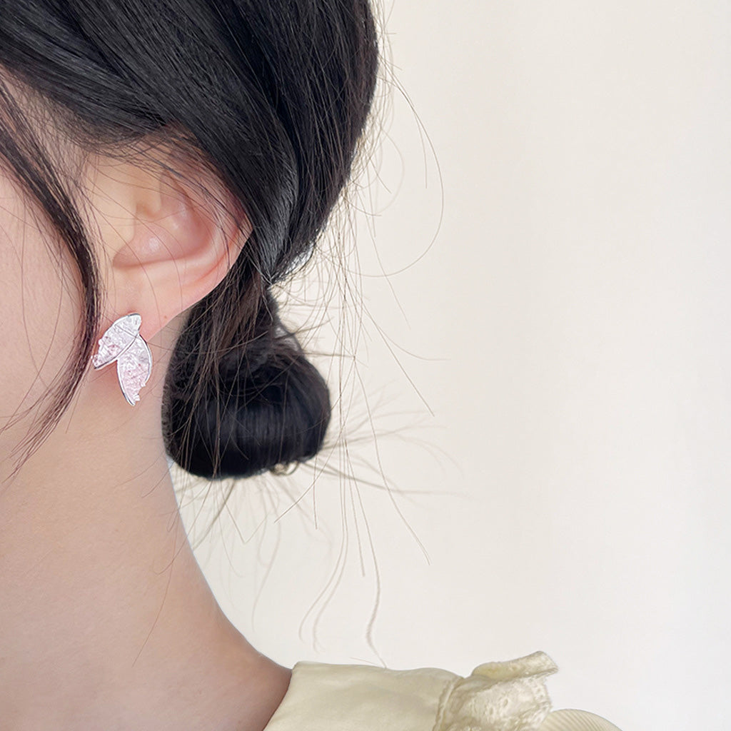 Model showcasing the silver plated leaf shape stud earrings