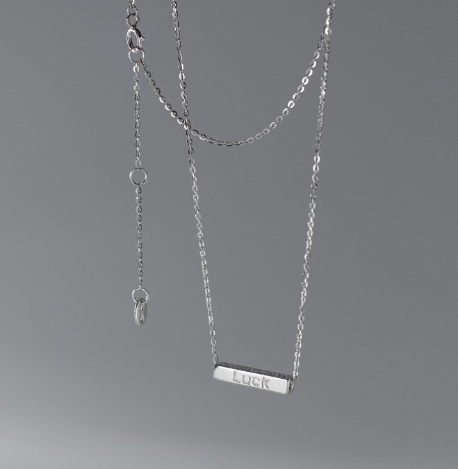Example of a custom engraved silver necklace with the word LUCK