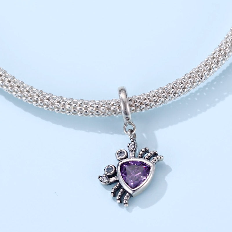 Sterling silver crab charm with purple bead on a necklace