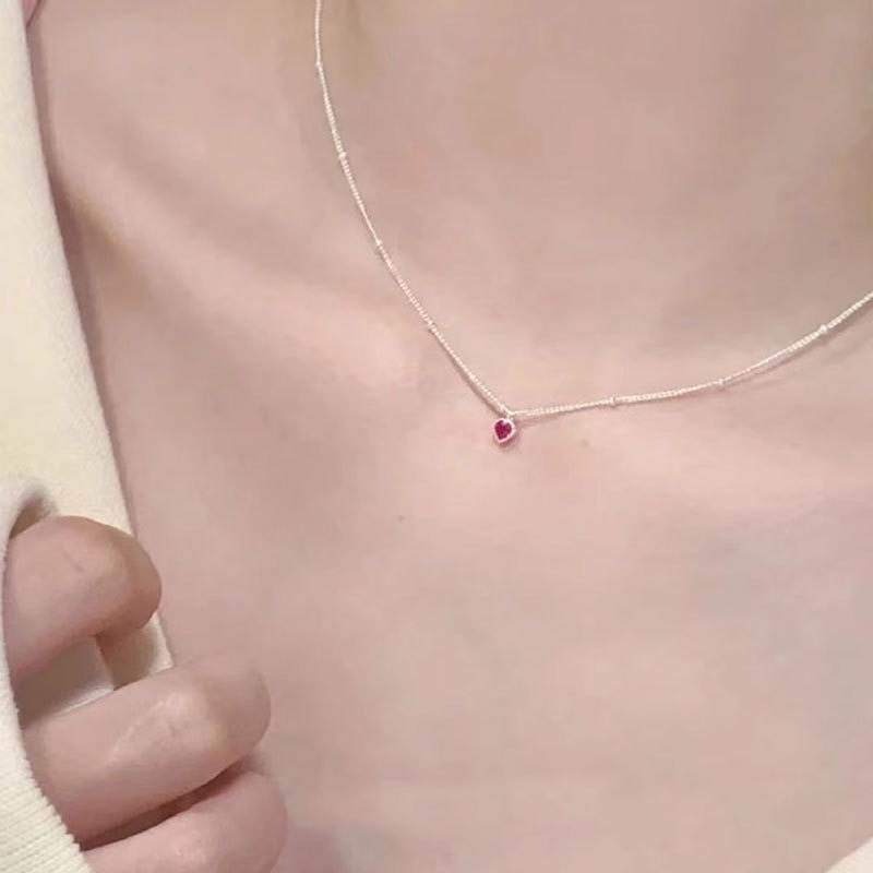 A model showcasing the elegant fit of the 925 Sterling Silver Red Heart Necklace.