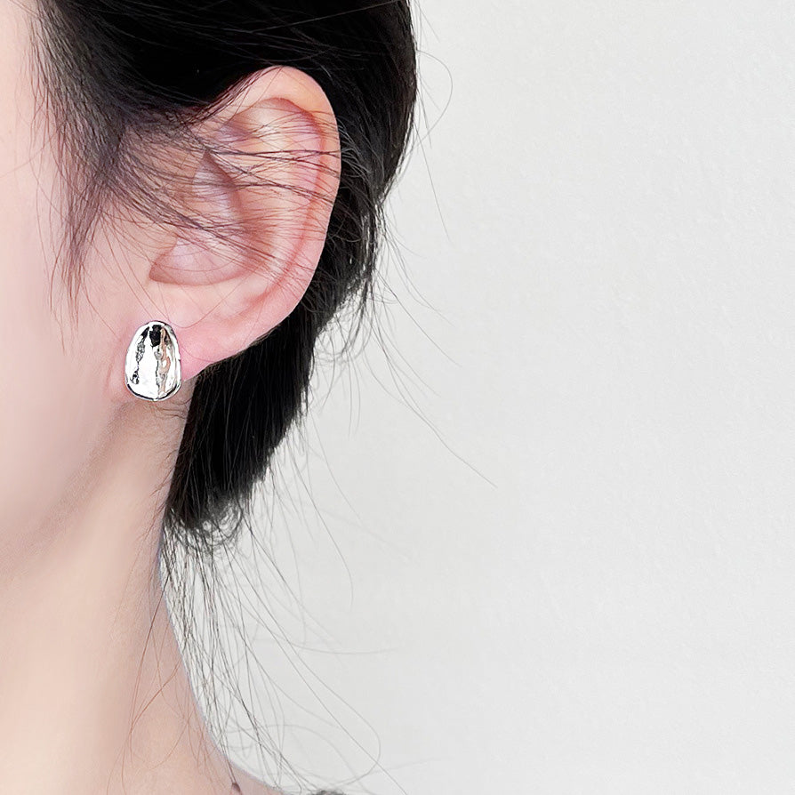 Model wearing the silver oval button stud earring