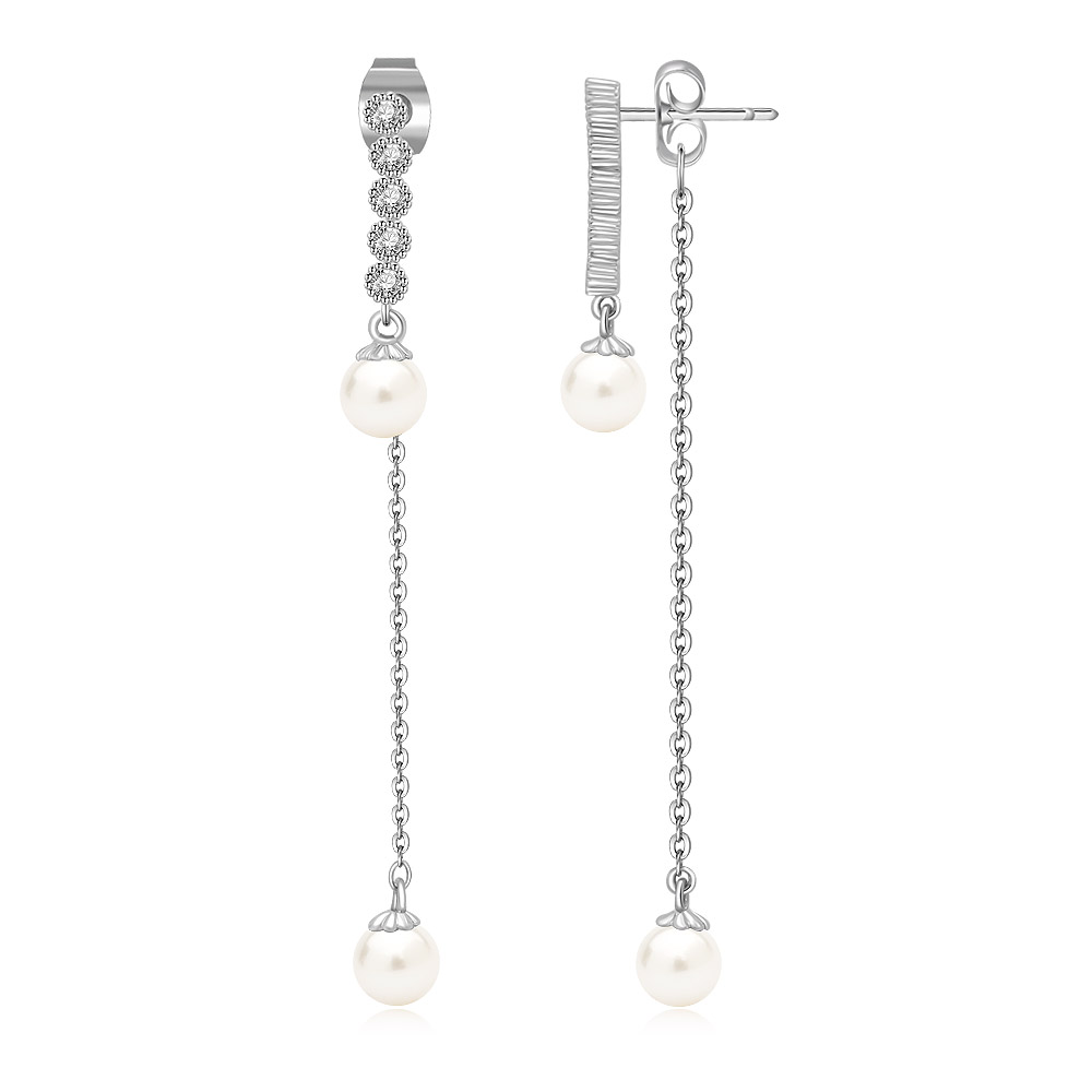 A detailed view of the pearl and cubic zirconia accents on the dangle earrings.