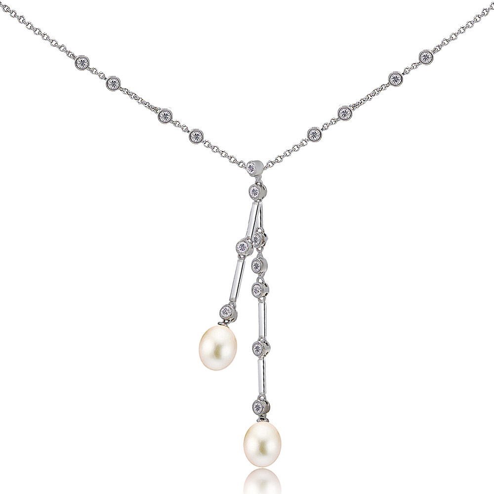 Detailed close-up of the pearl necklace with sparkling gemstones