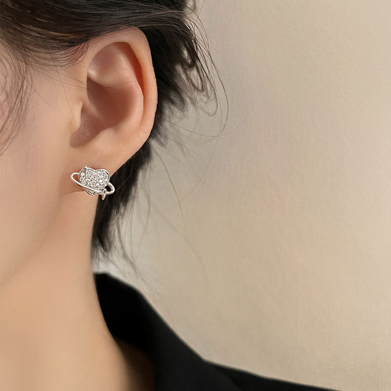Close-up of the sterling silver planet stud earring