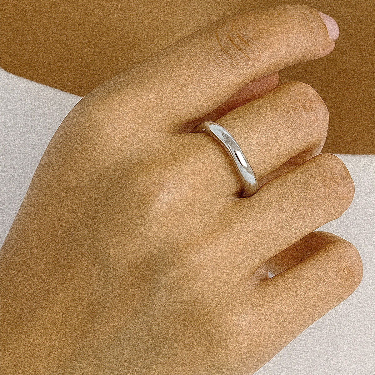 A model showcasing the elegant fit of a silver two-tone ring on her hand.