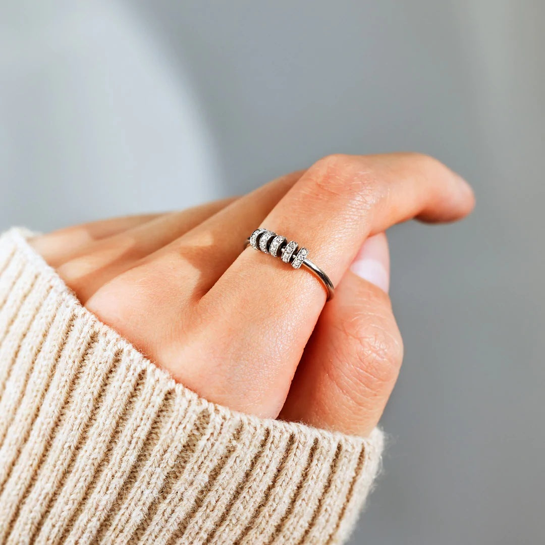 A model showcasing the 925 Sterling Silver Rotating Zircon Ring on her finger
