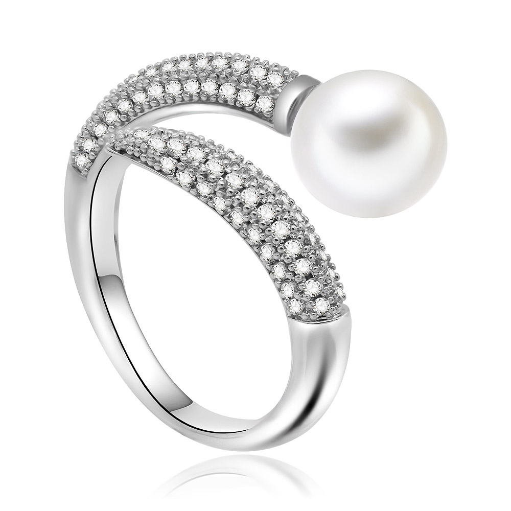 Detailed view of the pearl and cubic zirconia ring on a reflective surface