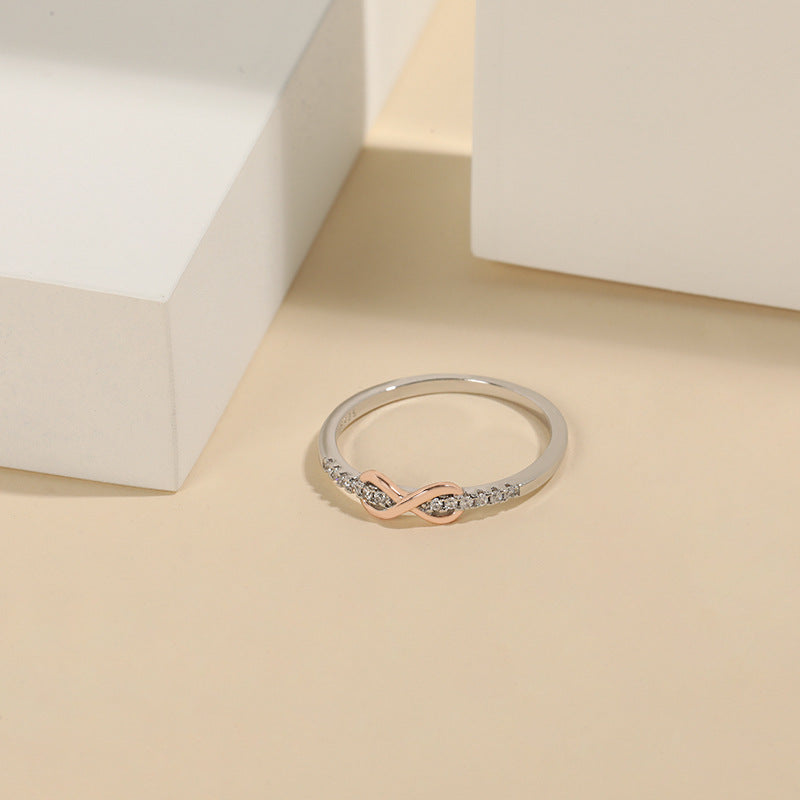 Detailed view of the two-tone infinity ring with zircon accents