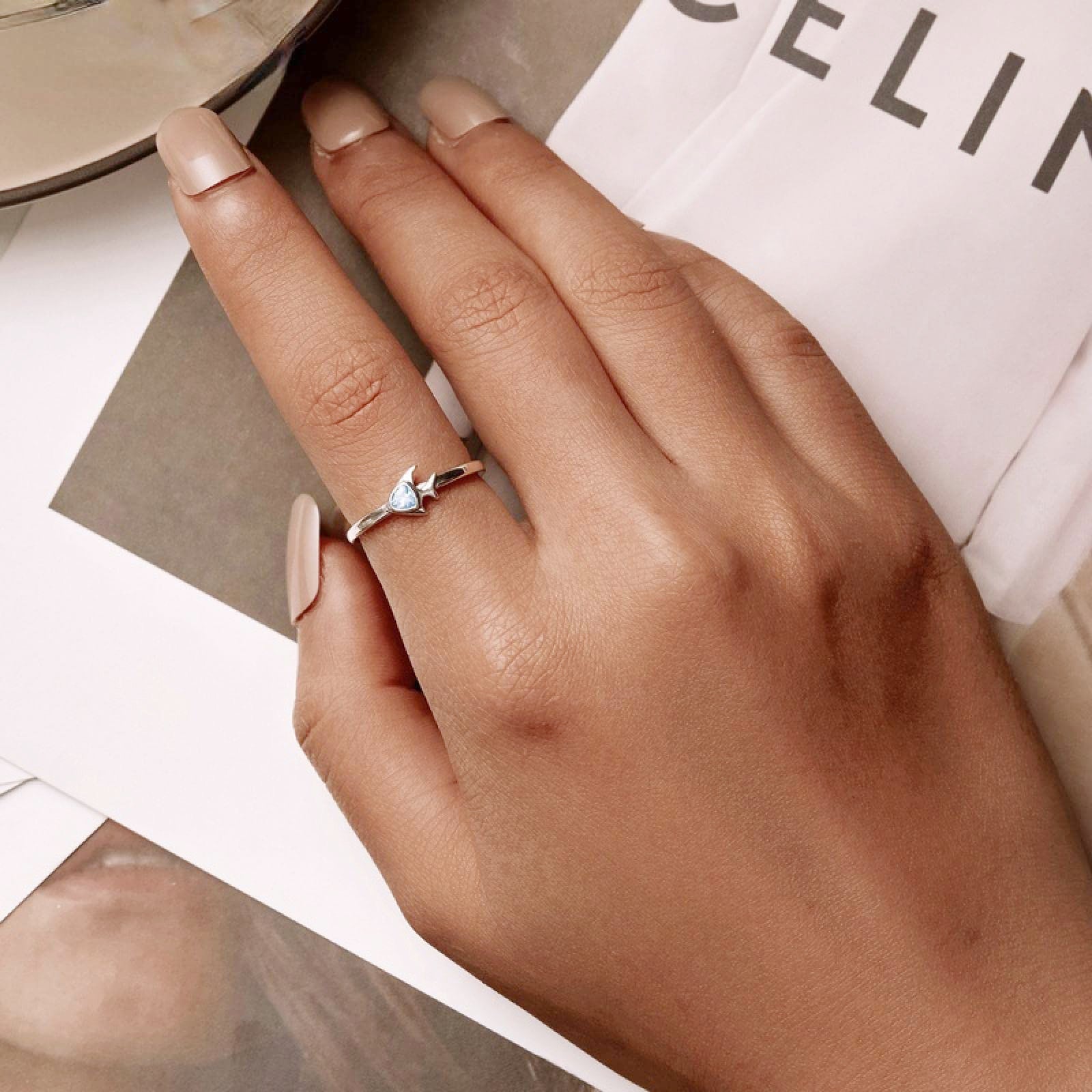 A sterling silver ring from the set featuring a delicate star design.