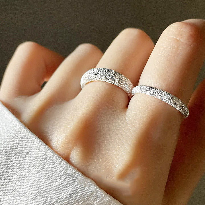 A model showcasing the versatile stacking possibilities of the 925 sterling silver frosted open rings.