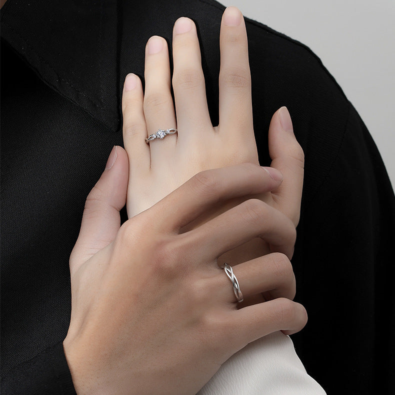 A couple wearing the matching twisted design silver rings to showcase the style.