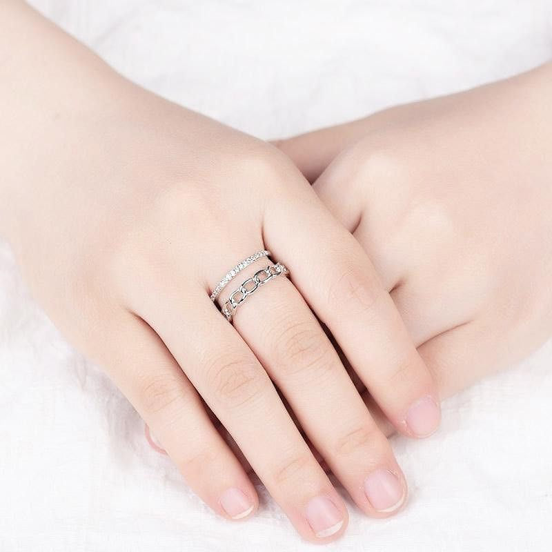 A model wearing the adjustable sterling silver layered link rings to showcase the fit and style.