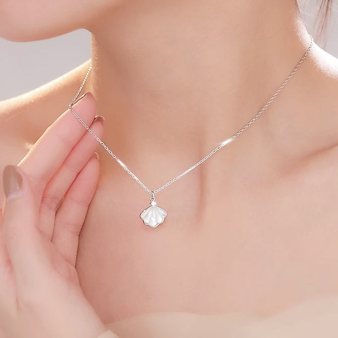 A woman wearing the elegant 925 sterling silver sea shell pendant necklace.