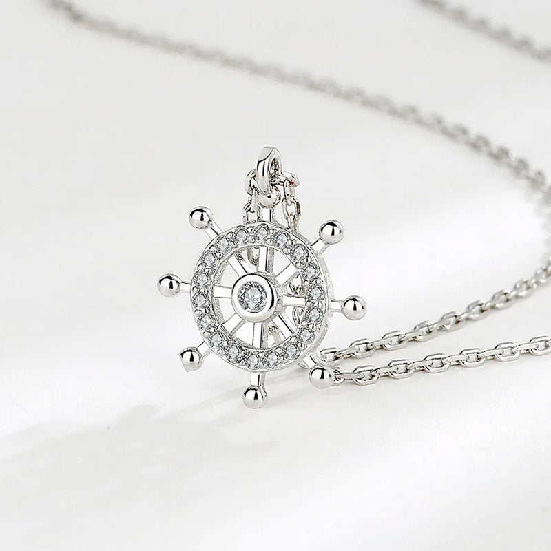 A model showcasing the 925 sterling silver ship's wheel pendant necklace.