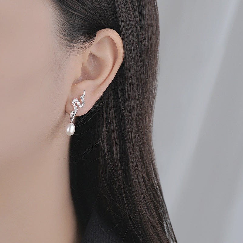 Model showcasing the gothic punk snake pearl drop earring