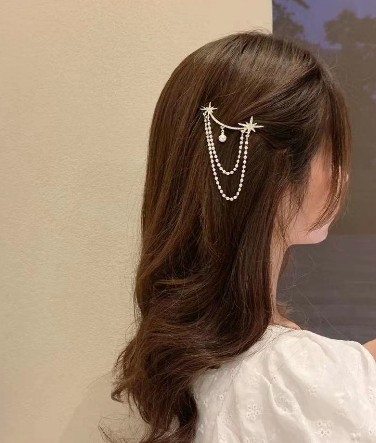 Model showcasing the Star Dangling Statement Hair Pin in her hair