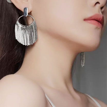 Model showcasing the elegant drape of the silver tassel earrings.